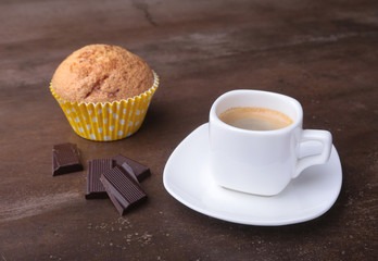 Homemade muffin with raisins and cup classic espresso coffee. selective focus.