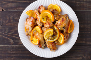 Orange chicken wings with sesame seeds. View from above, top, horizontal