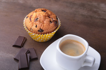 Homemade muffin with raisins and cup classic espresso coffee. selective focus.