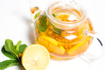 sea buckthorn tea with lemons on white background