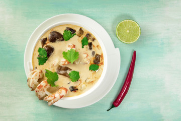 Tom Yam, traditional Thai soup with shrimps and mushrooms, on teal