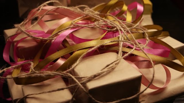 Boxes of different sizes, packed in brown paper and colorful ribbon, background