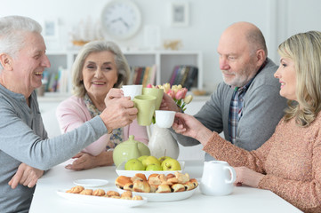 two  Senior couples drinking tea 