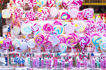 Colorful lollipops on stick for sale in shop window