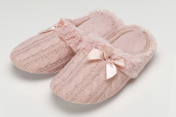 Pair of pink ladies slippers on white background