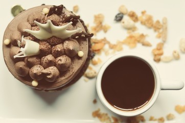 chocolate cake on the white plate with a cup of coffee, food macro photography decoration concept for new year party.