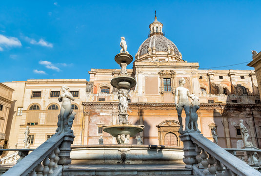 The Pretoria Fountain with the dome of Santa Caterina in the background in Palermo, Sicily, Italy