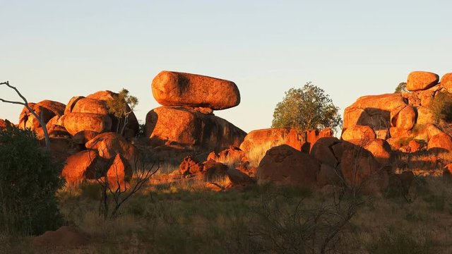 zoom in shot of the devil's marbles in australia's northern territory at sunset