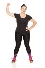 Fototapeta premium Chubby woman posing in fitness clothing on white background