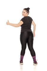 Back view of chubby woman in fitness clothing on white background