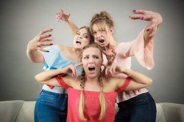Woman being bullied by two females