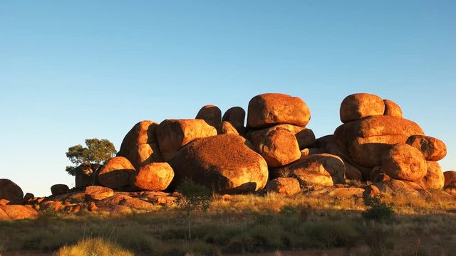 a panning view of the devil's marbles in australia's northern territory at sunrise