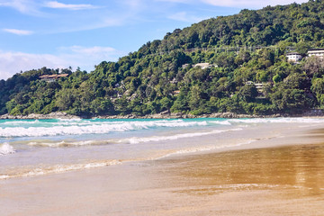 Obraz premium Warm blue sea. White waves. Green rock