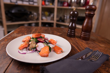 Salad with grilled salmon and  radish 
