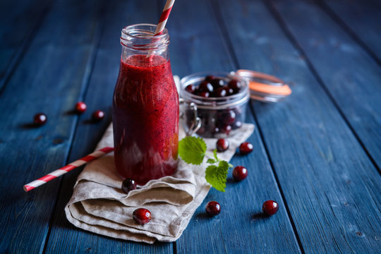 Cranberry smoothie in a glass bottle