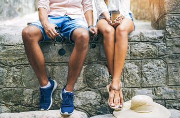Young couple in love traveling, old city center, legs close up