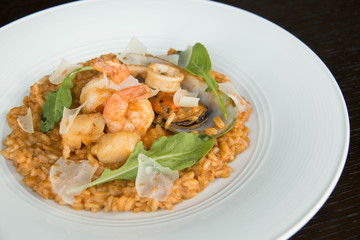 Fototapeta na wymiar Risotto with seafood on white plate