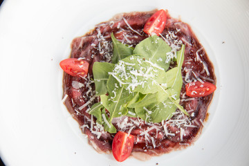  beef carpaccio with sliced on white plate