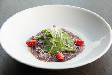  beef carpaccio with sliced on white plate