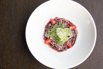  beef carpaccio with sliced on white plate