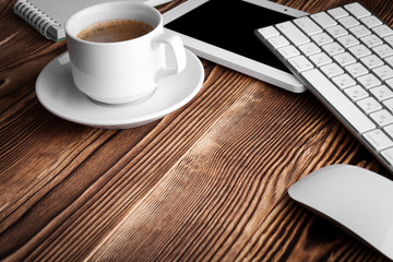 Top view of studying process with copybook, book and laptop. Cups of coffee on the table