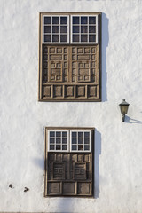 typical wooden windows at the whitewashed facade of a house in rural style in Lanzarote