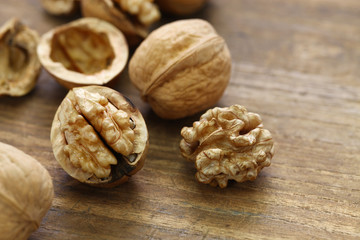 walnuts, kernel and shell on wooden background