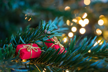 Little red present ornaments on a Christmas tree