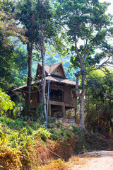 Beautiful green road walkway to the Viewpoint from Kep National Park, Cambodia. Cambodian village, typical rural house building