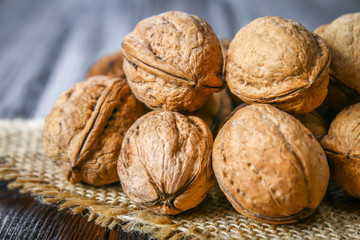 Shell and walnut bones on a brown wooden table.
