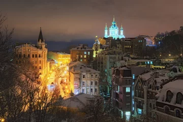 Deurstickers View of the Andreevsky Descent and St. Andrew's Church at background in winter evening. The street, often advertised by tour guides and operators as "Montmartre of Kyiv", is a major tourist attraction © evgenij84