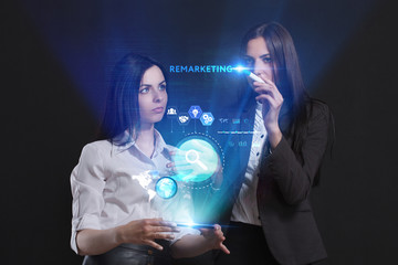 The concept of business, technology, the Internet and the network. A team of business women working on the virtual screen of the future and see the inscription: Remarketing