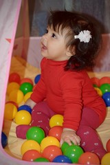 Fototapeta na wymiar Lovely baby playing with balls