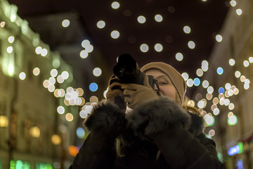 Woman photographer makes photos in the night city