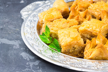 baklava turkish traditional delight on a dark wood background. toning.