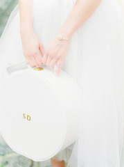 bride's hands holding hat box