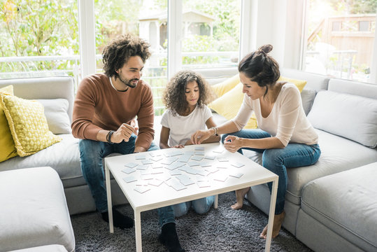 Family sitting on couch , playing memory game