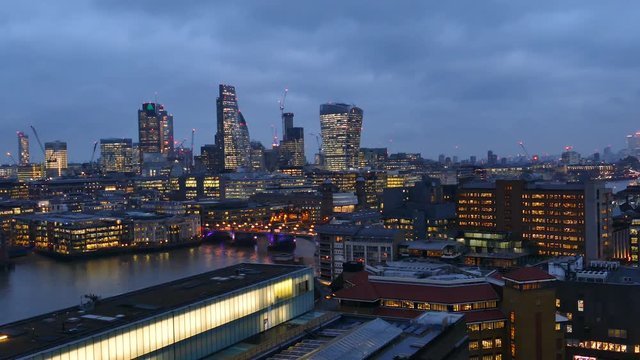 Footage Of Business Center Cityscape With View Of Thames River In London, UK At Night.