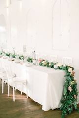 Wedding dining table with floral garland