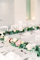 Decorated wedding dining table with floral garland