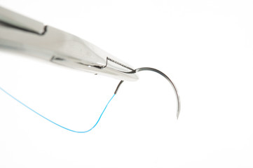 NEEDLE HOLDER AND SUTURE