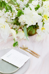 White and green Spring florals on dining table