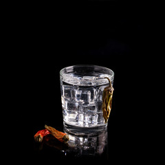 Drink white (vodka, gin, mineral water) in a transparent glass with ice cubes