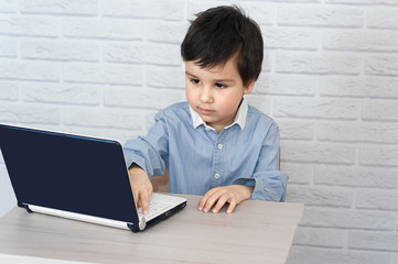 Concept of little businessman, webmaster, programmer, developer, Website designer. Little child and laptop, computer, notebook