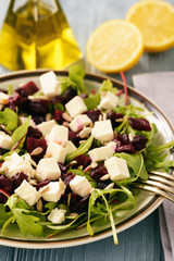 Healthy beetroot salad with feta cheese, arugula and sunflower seeds.