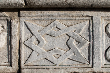 Abstract and geometric stone decorations on the facade of the Duomo of Como. Late Gothic and Renaissance decorations in northern Italy. Ancient patterns and Gothic geometries