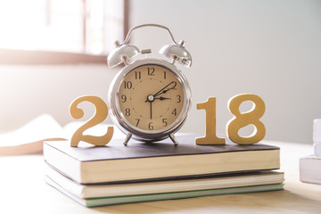 Naklejka premium 2018 Happy New Year with clock , book on wood isolated white background,Vintage tone,Copy space for your text.