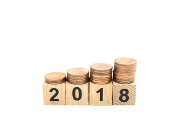 Miniature toy: wood block with 2018 and stack of coins on top of it , business ,financial, Success, Business Growth concept.