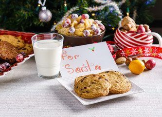 freshly baked chocolate chip cookies for Santa on a table with blurred background.