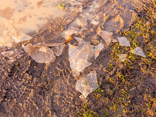 broken ice on mud floor walk surface outside texture winter frost